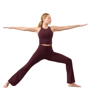 The Elation High Rise Flare Pants are dark burgundy yoga pants featuring a high waist and a flared leg design. The pants provide a snug fit around the waist while allowing movement through the legs, ideal for yoga or casual wear.