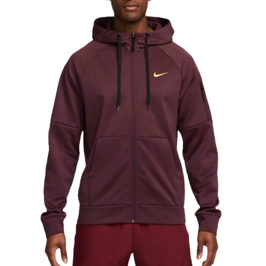 Nike Therma-FIT Hoodie in maroon features a full zip, front pockets, drawstring hood, and a small zip pocket on the left sleeve. A gold Nike swoosh is displayed on the chest.