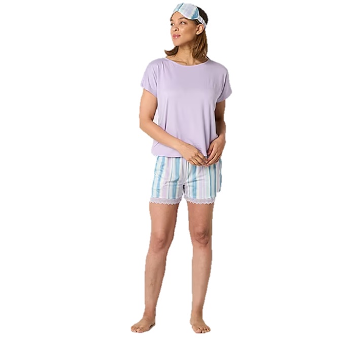 A woman wears a 3-piece pajama set, including a light purple short-sleeve top, striped shorts with lace trim, and a matching striped sleep mask.