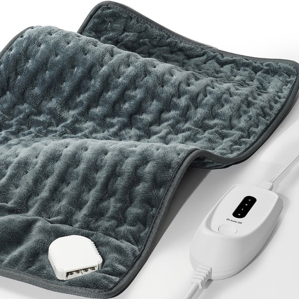A gray heating pad with a textured surface and an attached white controller featuring multiple heat settings.