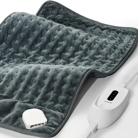 A gray heating pad with a textured surface and an attached white controller featuring multiple heat settings.