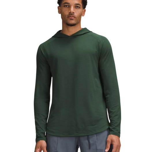 A green, long-sleeve hoodie designed for training from lululemon, made with lightweight, breathable fabric, featuring a minimalist design with a streamlined fit.