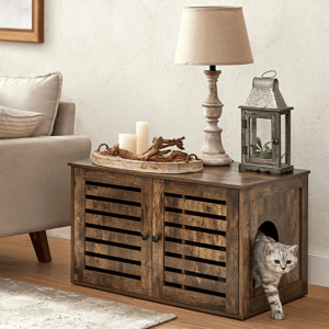 Rustic wooden cabinet with a side opening for pets; decorated with a candle tray, table lamp, and metal lantern. Beige sofa and patterned rug on the side.