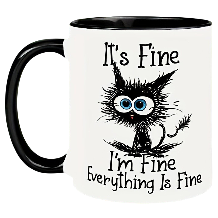 A white mug with a black handle displays a cartoon cat with wide eyes and messy fur. The text reads: \“It's Fine, I'm Fine, Everything Is Fine.\“