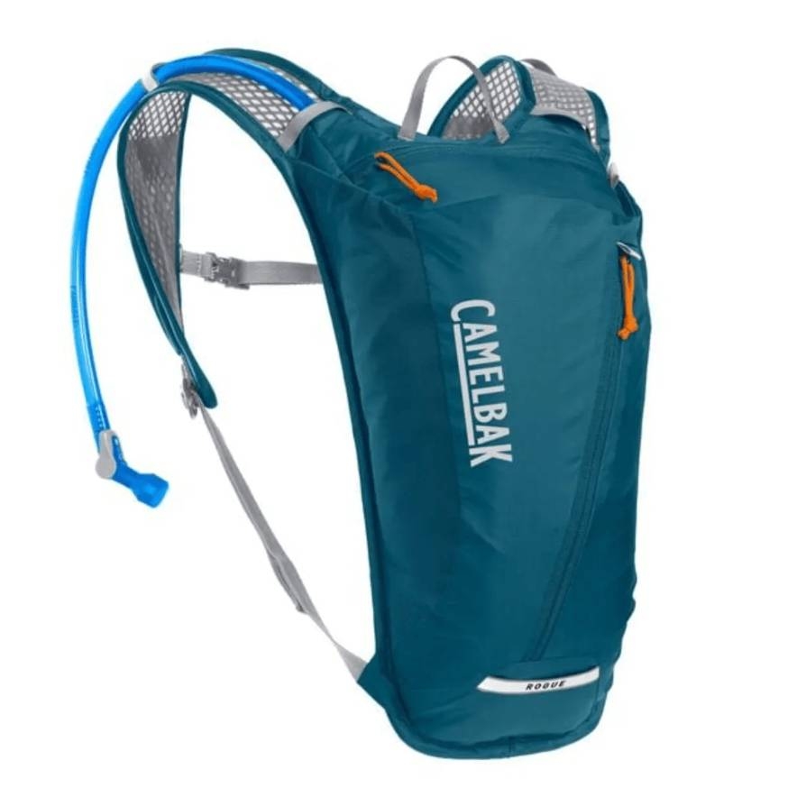 A blue CamelBak hydration pack featuring adjustable shoulder straps, a mesh back panel, an accessible zip pocket, and an attached hydration tube with a bite valve for hands-free drinking.