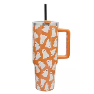 A tall, orange tumbler with a handle, decorated with white ghost patterns. It features a black straw and a silver lid.