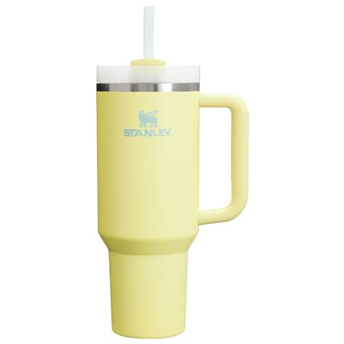 A yellow Stanley travel mug with a handle, featuring a straw and lid.