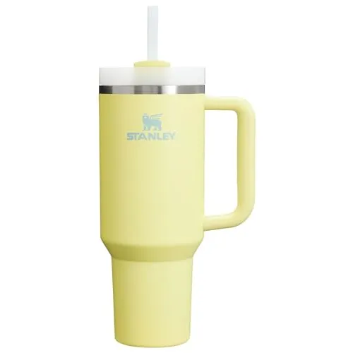A yellow Stanley travel mug with a handle, featuring a straw and lid.