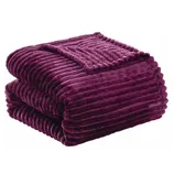A plush, ribbed, dark purple blanket is folded neatly.