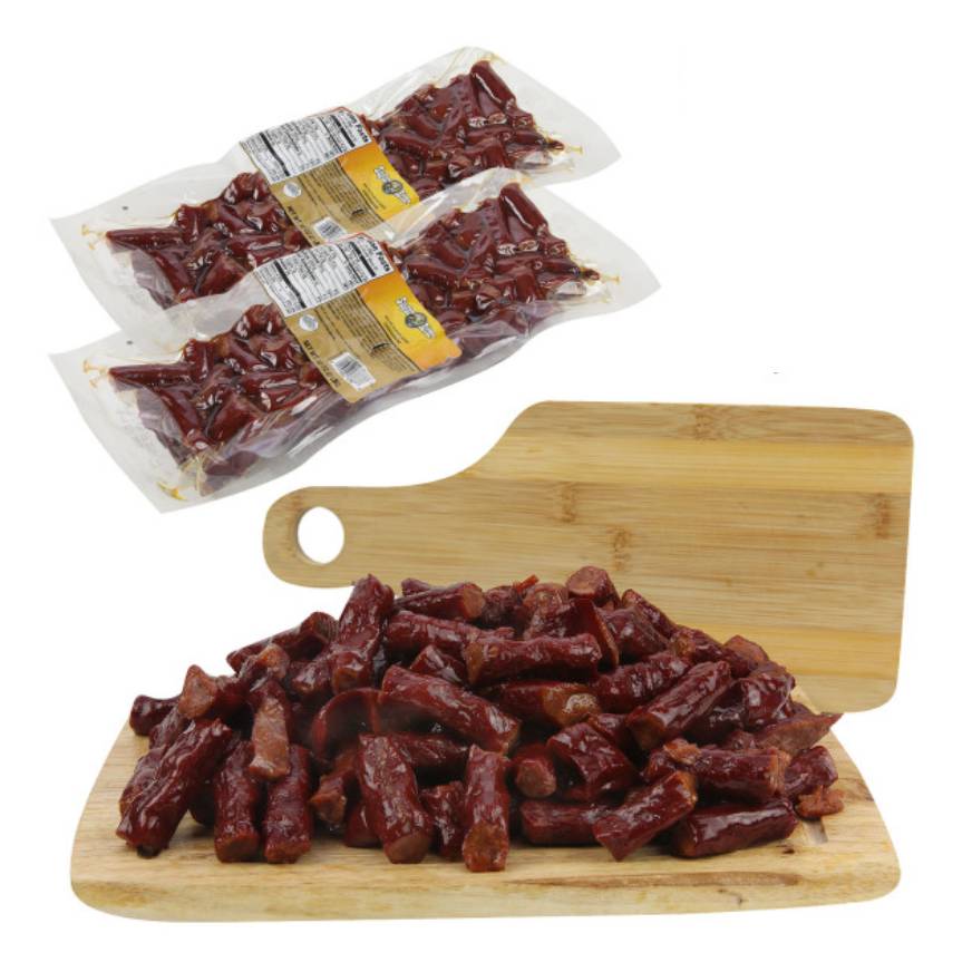 Packaged smoked sausages on a wooden cutting board with additional sealed packages in the background.