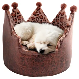 A small white dog is sleeping in a crown-shaped pet bed with leopard print and plush pom-poms.