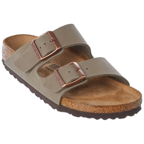A sandal featuring a tan footbed, dual adjustable straps, and copper-colored buckles.