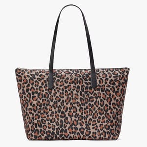 A leopard print tote bag with black shoulder straps and a wide, rectangular shape.