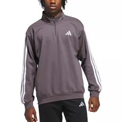 A person is wearing a dark gray Adidas half-zip pullover with white striped sleeves and a logo on the chest, paired with black pants featuring the same logo.