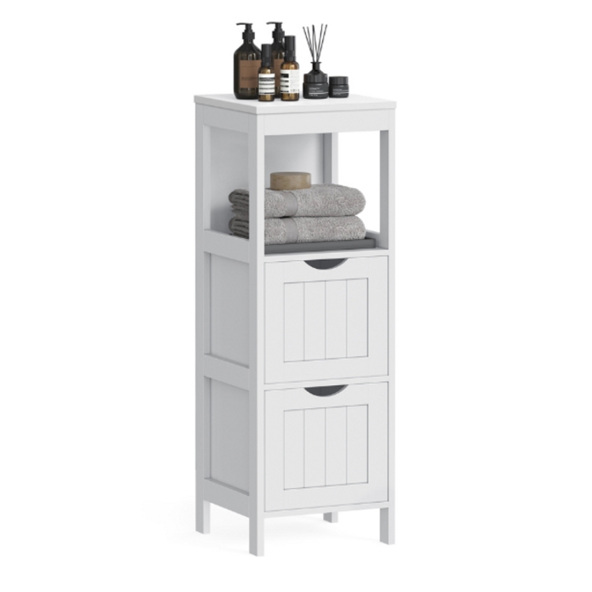 White bathroom storage unit with two drawers and an open shelf, holding folded towels and various toiletries like bottles and a diffuser on top.