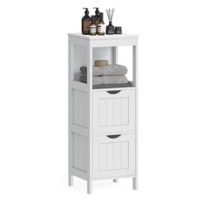 White bathroom storage unit with two drawers and an open shelf, holding folded towels and various toiletries like bottles and a diffuser on top.