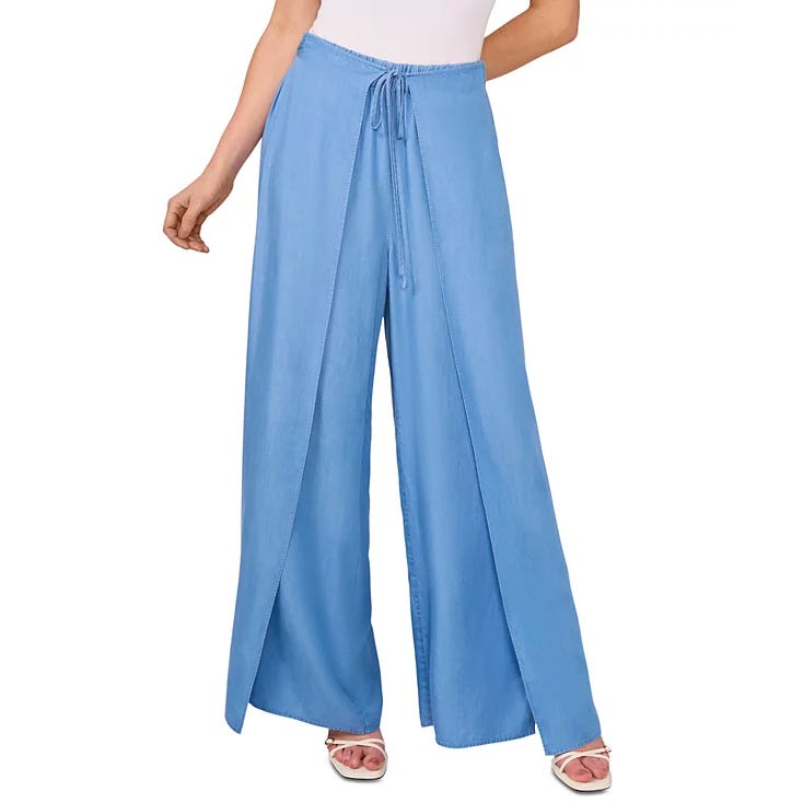 Light blue wide-leg pants with a front tie and slit detail, paired with white sandals.