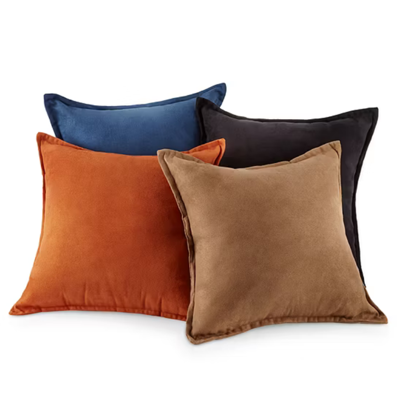 Four square throw pillows in blue, black, orange, and beige are displayed.
