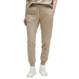 Beige jogger pants with an elastic waistband, drawstring, and cuffed ankles, paired with white sneakers.