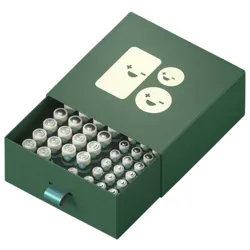 A green drawer-style box containing multiple AA batteries, decorated with minimalist smiling face graphics on the lid.