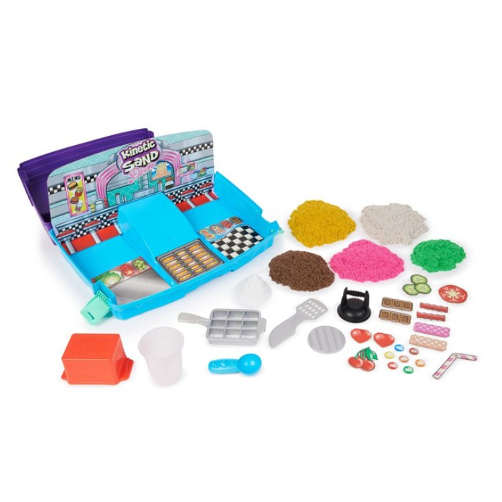 Kinetic Sand playset designed as a diner, featuring colorful kinetic sand piles and accessories like molds, utensils, and decorative pieces for creating pretend food items.