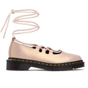 A pastel pink lace-up shoe with a black sole featuring yellow stitching, and long wrap-around ankle laces.