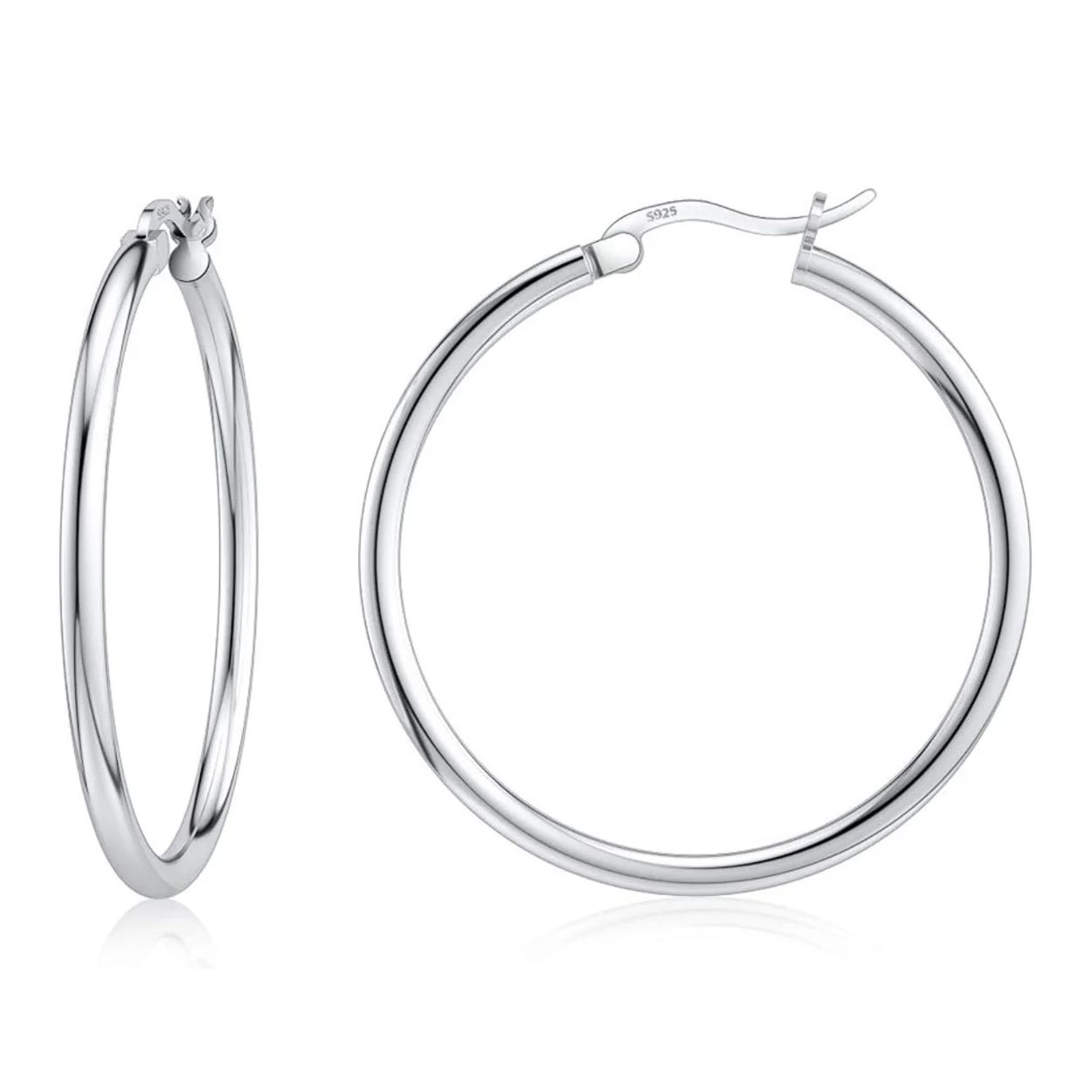 Silver hoop earrings with a latch back design, marked with \“925\“ indicating sterling silver.