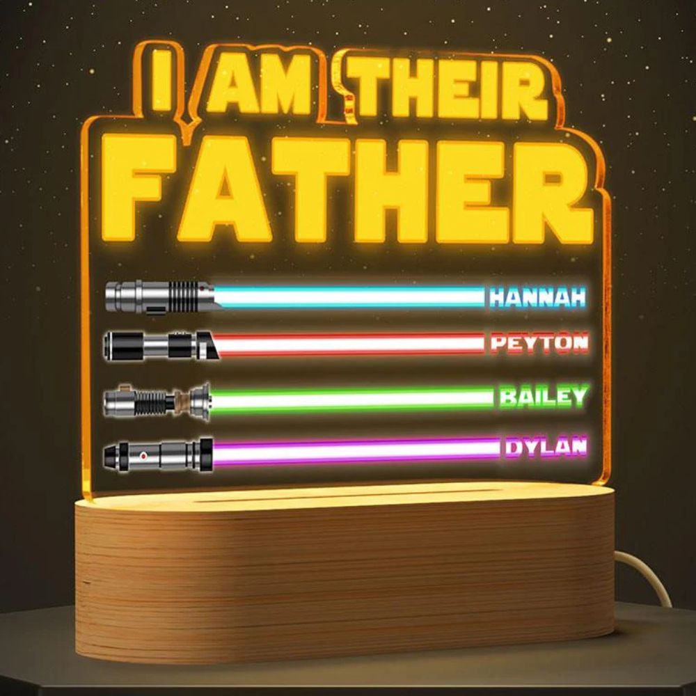 A lit sign displays \“I AM THEIR FATHER\“ above four lightsaber designs with names: Hannah (blue), Peyton (red), Bailey (green), and Dylan (purple).