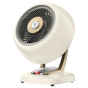 A vintage-style cream tabletop fan with a round body, metal grille, and adjustable base designed for whole-room air circulation.