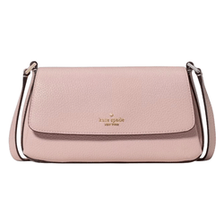 A pink, pebble-leather crossbody bag with a front flap and a strap, featuring the \“kate spade new york\“ logo in gold lettering.