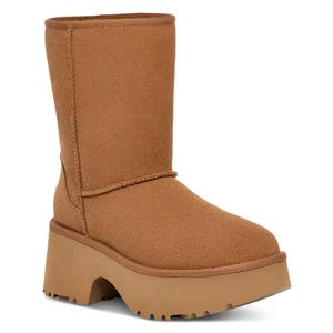 Brown Ugg Classic Boot with a high platform sole and chunky heel, featuring a mid-calf height and soft, suede material.