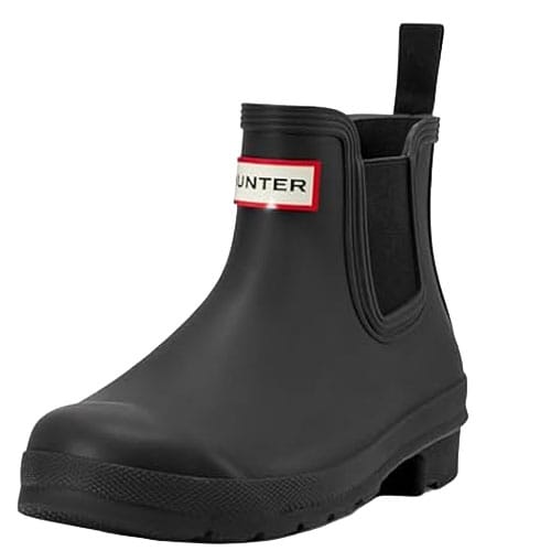 A black, ankle-height waterproof boot with a pull tab and elastic side panels, featuring a red and white brand label on the front.