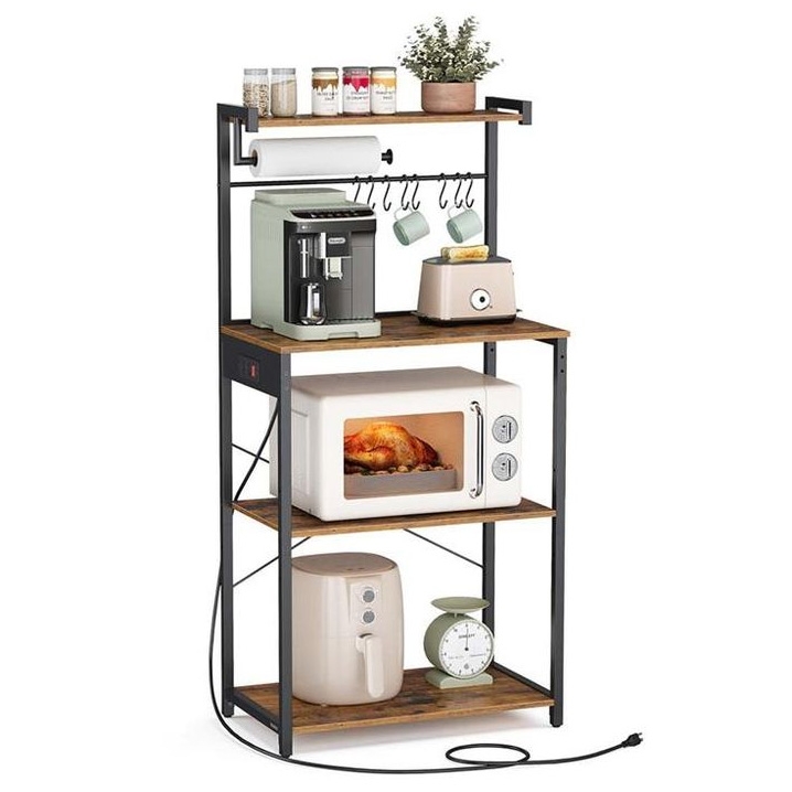A multi-tiered baker's rack featuring a top shelf with jars and a potted plant, a middle shelf with a coffee maker and toaster, a third shelf with a microwave containing a roast chicken, and a bottom shelf with an air fryer and kitchen scale, with hangers and a paper towel holder.