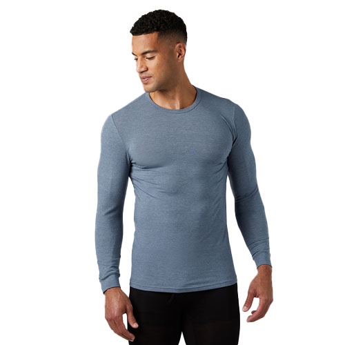 A man wearing a fitted, long-sleeve, light blue crew neck shirt paired with black pants. The shirt features a simple design suitable for casual wear.