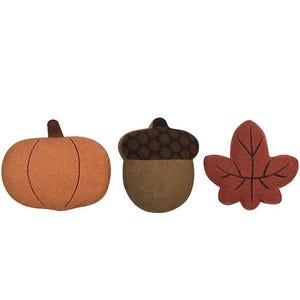 Three harvest-themed coir doormats in the shapes of a pumpkin, an acorn, and a maple leaf.
