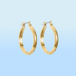 A pair of gold hoop earrings with a polished finish on a light blue background.