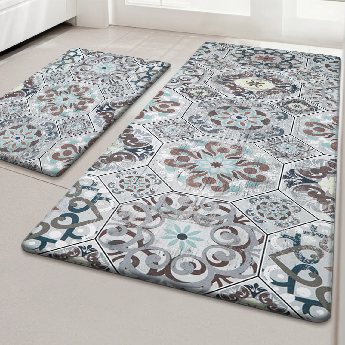 Two patterned floor mats with intricate geometric and floral designs in muted colors, featuring hexagonal and circular motifs.
