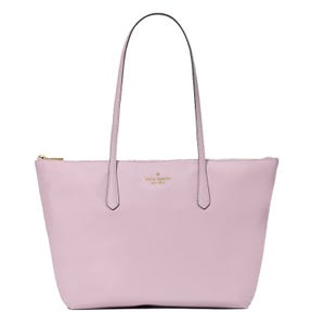 A light pink Kate Spade New York tote bag with two shoulder straps and a zippered top closure.