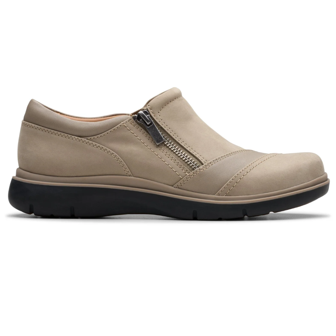 Beige slip-on shoe with a decorative side zipper and a robust black rubber sole.
