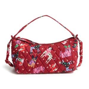 The Outlet Mini Slouchy Crossbody is a red quilted bag featuring a whimsical animal print, a top zip closure, and an adjustable shoulder strap.