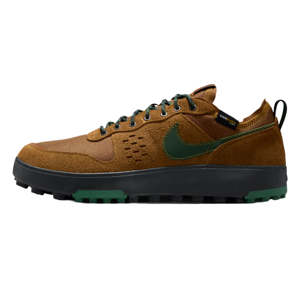 Nike sneaker with brown and green accents, featuring a suede and mesh upper, green swoosh, rugged outsole, and black midsole.