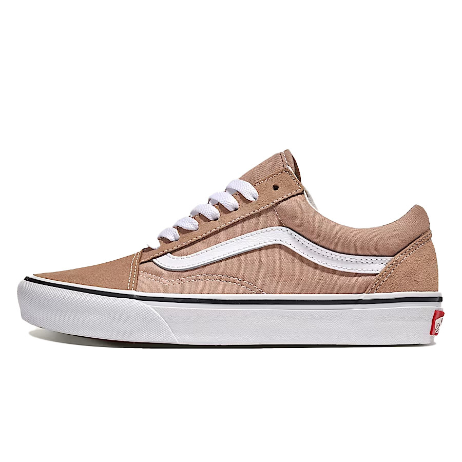 A beige low-top sneaker with a white sole, white laces, and a signature white side stripe, resembling the Vans Old Skool style.