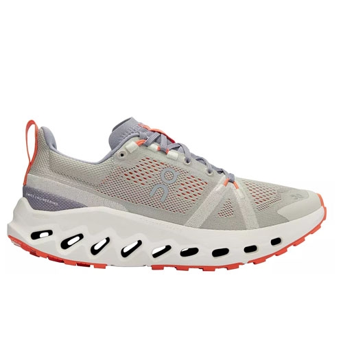 A light gray athletic sneaker with red-orange accents, featuring a distinctive white sole with black oval cutouts for cushioning and design.