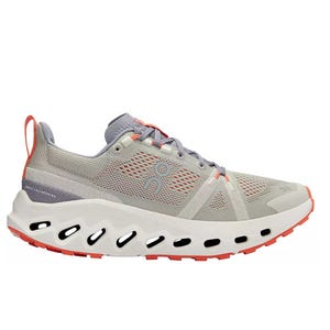 A light gray athletic sneaker with red-orange accents, featuring a distinctive white sole with black oval cutouts for cushioning and design.