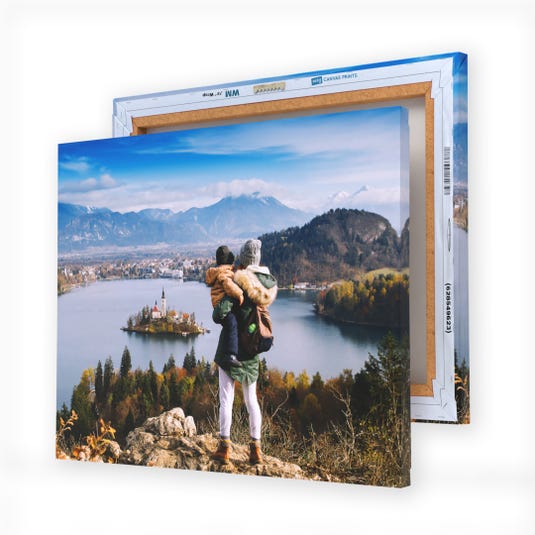 Canvas art prints featuring a person overlooking a scenic lake and island landscape, backed by mountains and partially obscured by another canvas frame.