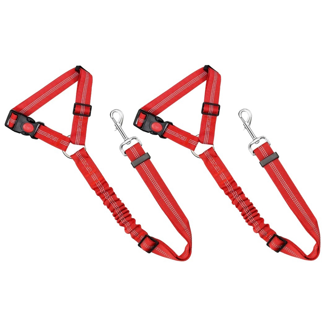 Red adjustable dog harnesses with reflective stitching, featuring a safety buckle and a metal clip for leash attachment.