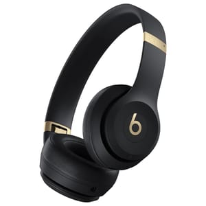 Black over-ear wireless headphones with gold accents, featuring the signature \“b\“ logo.