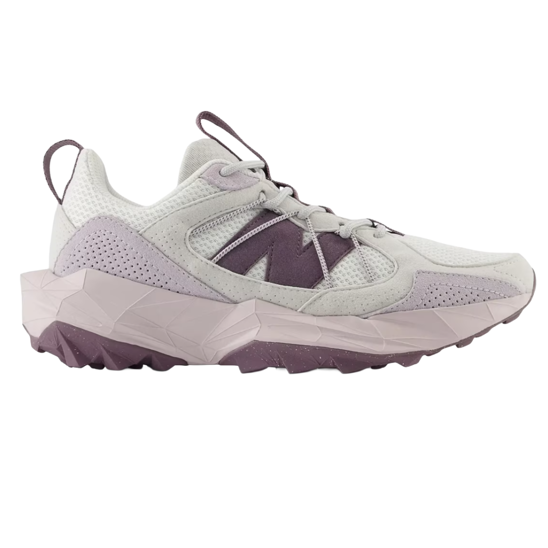 A stylish sneaker featuring a light gray mesh and suede upper with purple accents, prominently displaying a large \“N\“ logo and set on a geometric-patterned midsole with a rugged outsole.