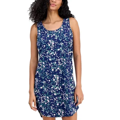 A sleeveless dress with a navy blue background featuring a floral pattern of small white and pink flowers with green leaves.