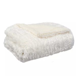 A white, fluffy, folded blanket with a soft, plush texture.